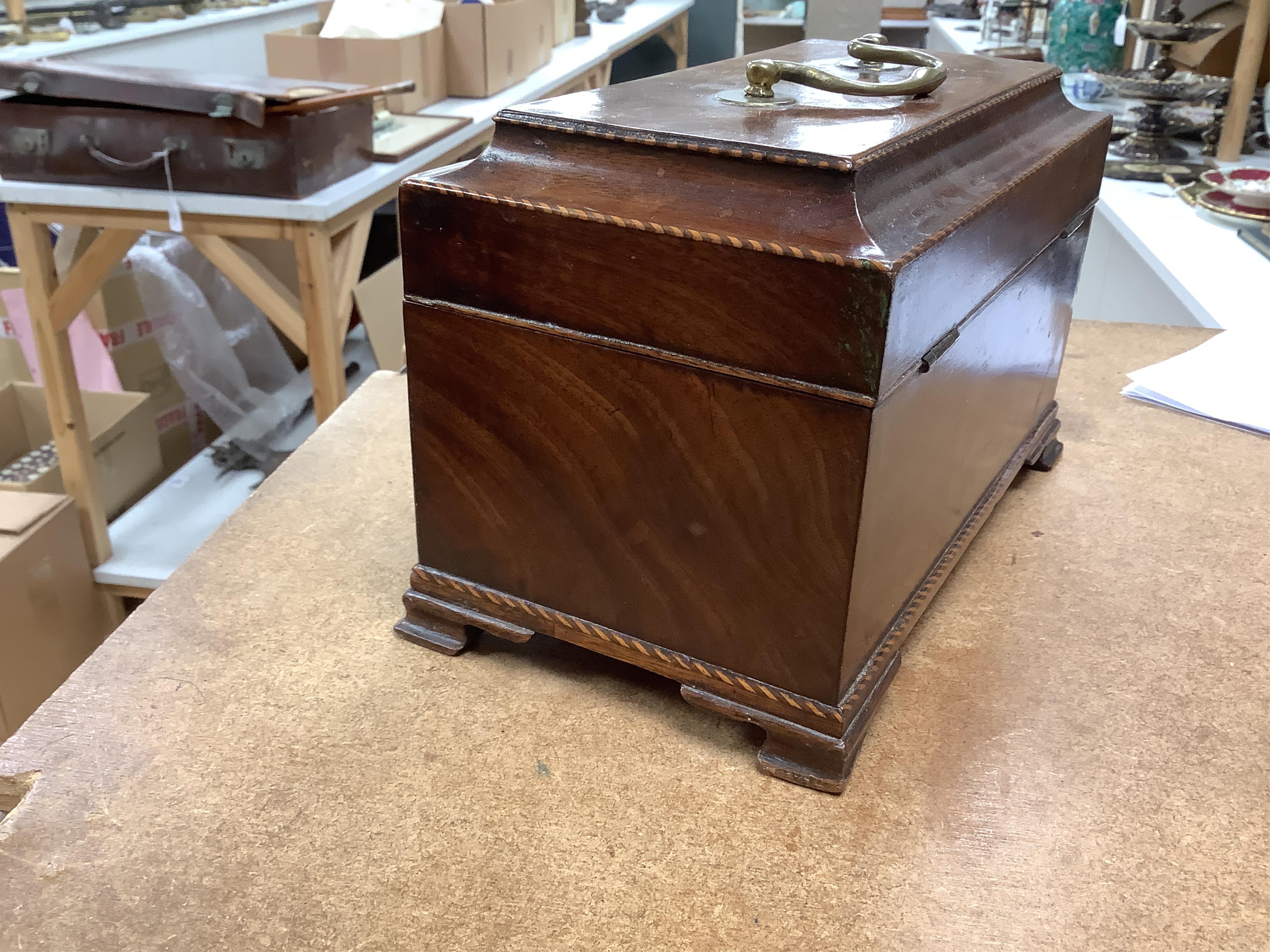 A George III mahogany tea caddy, containing tinned metal canisters, 25cm wide